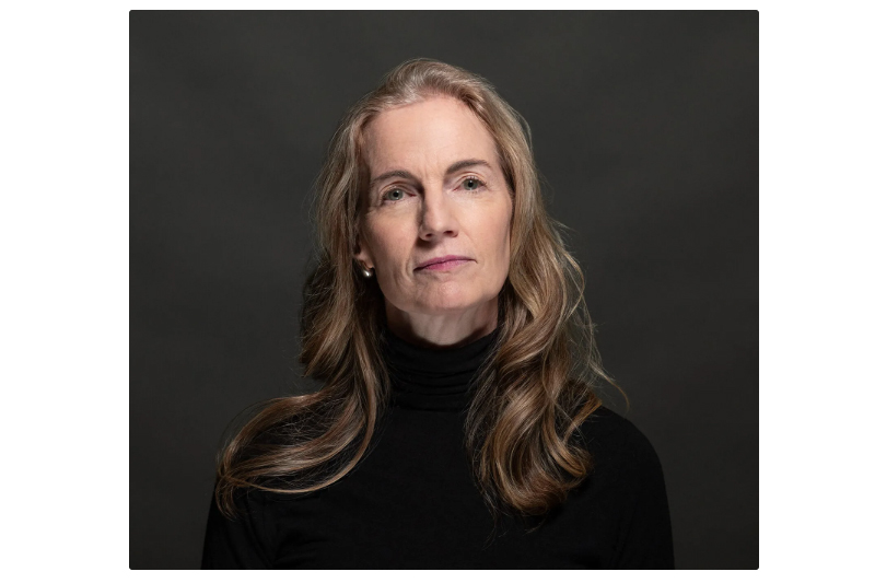 Portrait of journalist Allison Hunter against a dark gray background.